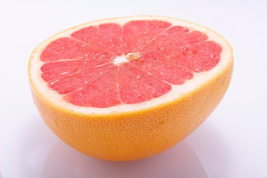 Red grapefruit, cut in half, fresh natural, juicy fruit on white