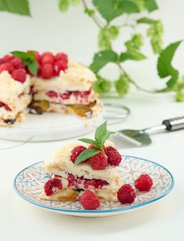 Round meringue pie with fresh raspberries on a white background, Pavlova dessert