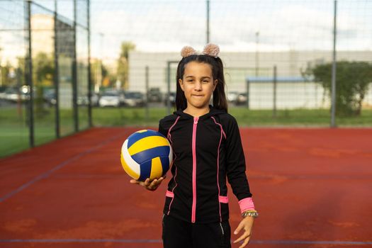 little girl with a volleyball ball.