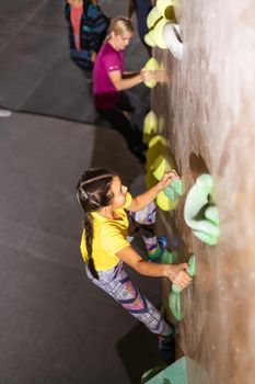 mother and daughter climb on the climbing wall. Family sport, healthy lifestyle, happy family.