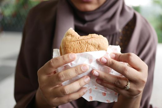 women hand holding beef burger top view ,