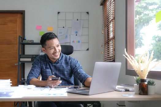 Male businessman and financial concepts about office work. Analysts discuss business with tablet and laptop.