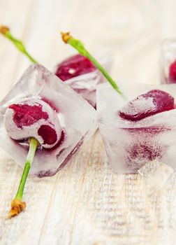 Berries frozen in ice cubes. Selective focus.