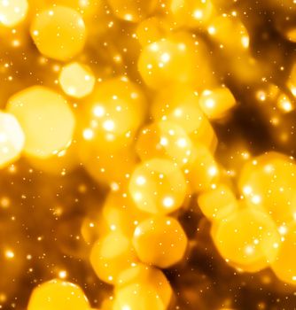 Golden Christmas lights, New Years Eve fireworks and abstract texture concept - Glamorous gold shiny glow and glitter, luxury holiday background