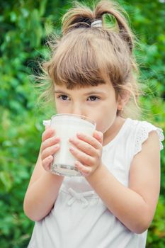 The child drinks milk and cookies. Selective focus.