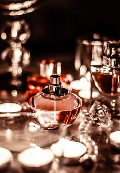 Perfumery, cosmetics branding and luxe concept - Perfume bottle and vintage fragrance on glamour vanity table at night, pearls jewellery and eau de parfum as holiday gift, luxury beauty brand present