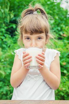 The child drinks milk and cookies. Selective focus.