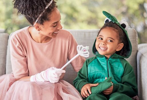 Love, family costume and smile on happy girl, child or kid playing dress up, having fun and bonding with mother. Happiness, princess mom and dinosaur child enjoy quality time together for Halloween.