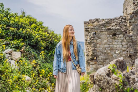Woman tourist walks through the old town of Bar in Montenegro. Happy tourist walks in the mountains. Suburbs of the city of Bar, Montenegro, Balkans. Beautiful nature and landscape.