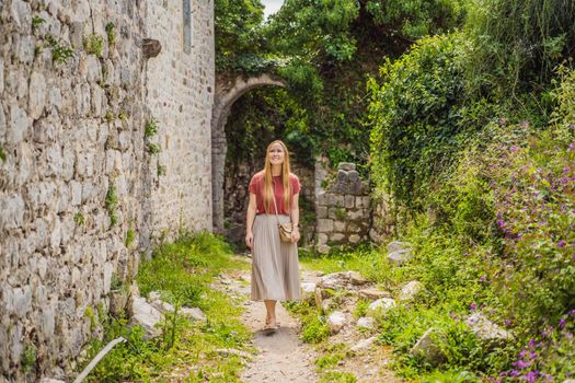 Woman tourist walks through the old town of Bar in Montenegro. Happy tourist walks in the mountains. Suburbs of the city of Bar, Montenegro, Balkans. Beautiful nature and landscape.