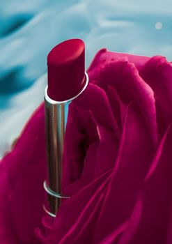 Cosmetic branding, luxe and fashion concept - Pink lipstick and rose flower on liquid background, waterproof glamour make-up and lip gloss cosmetics product for luxury beauty brand holiday design