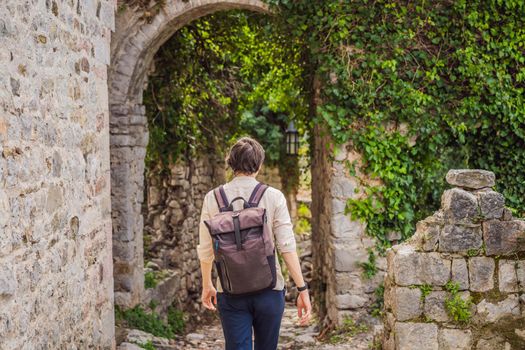 Man tourist walks through the old town of Bar in Montenegro. Happy tourist walks in the mountains. Suburbs of the city of Bar, Montenegro, Balkans. Beautiful nature and landscape.