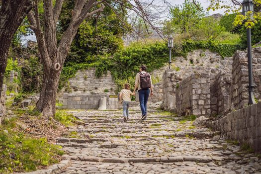 Dad and son tourists walks through the old town of Bar in Montenegro. Happy tourist walks in the mountains. Suburbs of the city of Bar, Montenegro, Balkans. Beautiful nature and landscape.