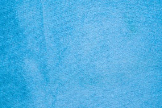 Spongebond texture in blue. Blue nonwoven polypropylene material texture background.