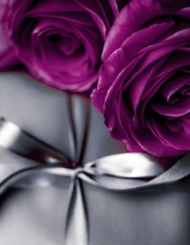 Luxurious design, shop sale promotion and happy surprise concept - Luxury holiday silver gift box and purple roses as Christmas, Valentines Day or birthday present