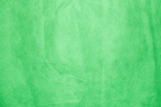 Synthetic non-woven material . Spongebond texture in green.