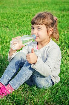 Baby drinks water from bottle. selective focus.