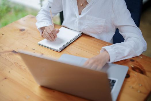 woman using a notebook and computer during a video conference, e learning concepts