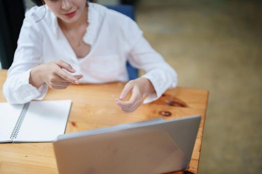 Portrait of a beautiful woman using a computer and earphone during a video conference