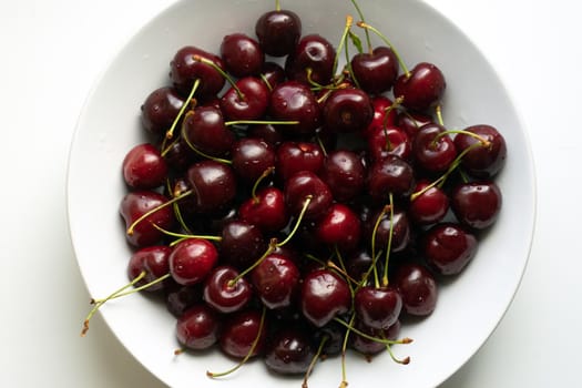 Healthy eating and food concept - cherries in white bowl. . High quality photo
