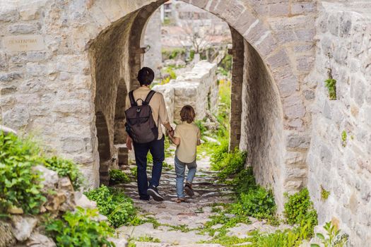 Dad and son tourists walks through the old town of Bar in Montenegro. Happy tourist walks in the mountains. Suburbs of the city of Bar, Montenegro, Balkans. Beautiful nature and landscape.