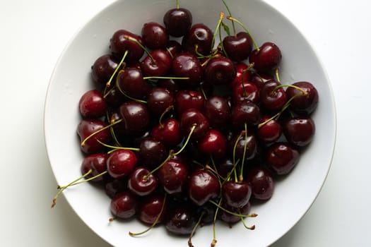 Healthy eating and food concept - cherries in white bowl. . High quality photo