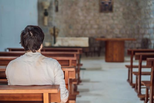 Christian man sitting in kirk. Faith, religious education, modern church.