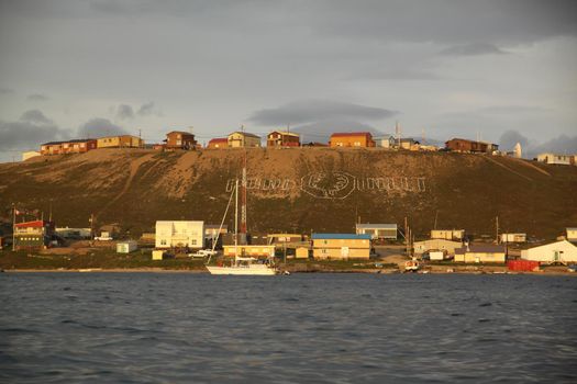 View of the community of Pond Inlet and the Pond Inlet sign in the north Baffin Region of Nunavut, Canada