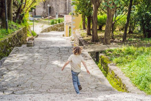 Boy tourist in Herceg Novi old town. Historical and touristic center of Herceg Novi. Montenegro.