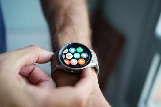 Granada, Andalusia, Spain - September 28th, 2022: Man using the app screen of the new Samsung Watch 5 Pro.