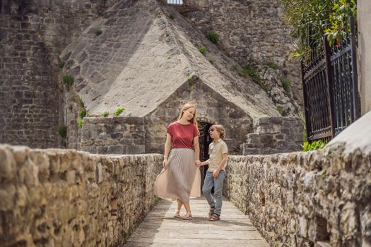 Mom and son tourists in Herceg Novi old town. Historical and touristic center of Herceg Novi. Montenegro.