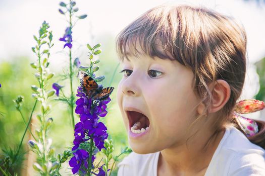 Child with a butterfly. Idea leuconoe. Selective focus.