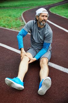 portrait of a senior man exercising and running outdoors