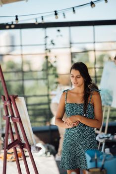 A young female artist evaluates her work in the process of writing