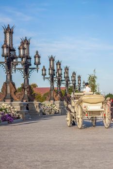 The rider drives a white carriage through the territory of the tourist complex. Elements of Gothic.