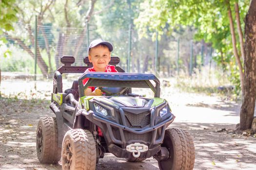 Entertainment park. Little boys compete on children's ATVs and cars. A fun pastime. Natural images with natural emotions. Childhood
