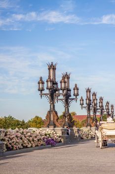 The rider drives a white carriage through the territory of the tourist complex. Elements of Gothic.