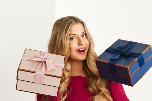 Happy woman holding gifts for birthday, anniversary, wedding, Valentines day or Christmas, luxury holiday present or beauty box subscription delivery concept