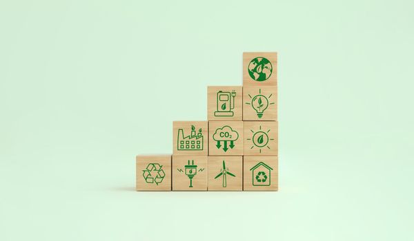 Carbon footprint ecological symbols on a wooden cube. Alternative energies to save the planet. Environmental concept, climate change. 3D rendering.