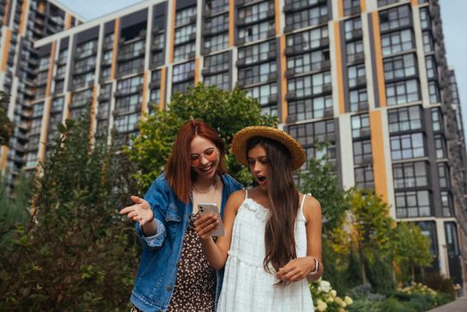 Two tourists with a phone on a city street