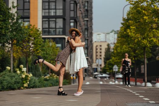 Meeting of two friends hugging in the street