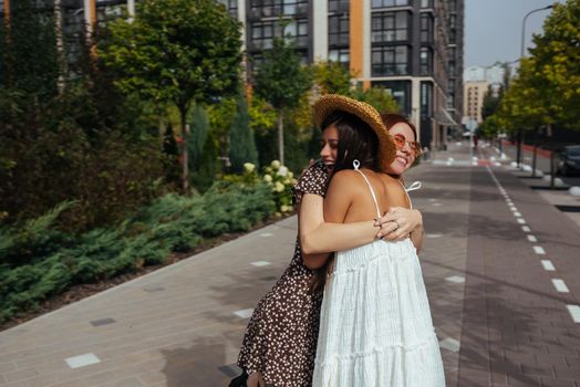 Meeting of two friends hugging in the street