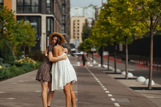 Meeting of two friends hugging in the street