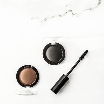 Cosmetic branding, blog and girly concept - Eyeshadows, black liner and mascara on marble background, eye shadows cosmetics as glamour make-up products for luxury beauty brand, holiday flatlay design