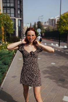 Fashion woman portrait of young pretty trendy girl posing at the city in Europe