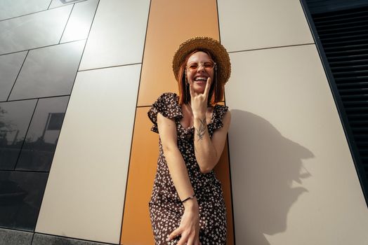 Cute young woman with a lovely sense of humour in an urban street laughing at the camera