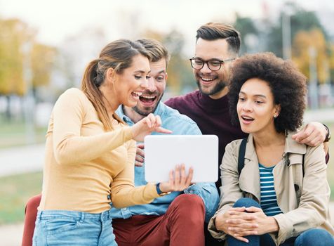 Group of young people having fun outdoors in a park