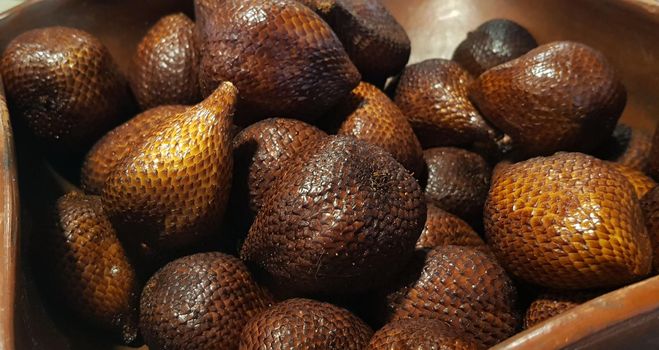 group of snake fruit or called salak in local indonesian language is a type of palm fruit commonly eaten also known as sala, the scientific name is Salacca zalacca.