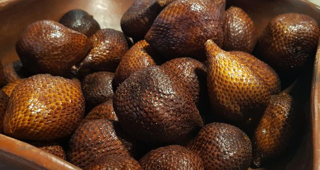 group of snake fruit or called salak in local indonesian language is a type of palm fruit commonly eaten also known as sala, the scientific name is Salacca zalacca.