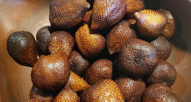 group of snake fruit or called salak in local indonesian language is a type of palm fruit commonly eaten also known as sala, the scientific name is Salacca zalacca.